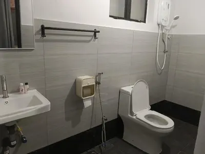 a bathroom with a toilet and a sink at Olly de Home Ent in Batu Gajah