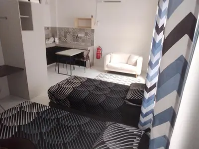 a room with a bed and a table and a chair at IFS SoHo 2 Basic Studio in Seri Iskandar