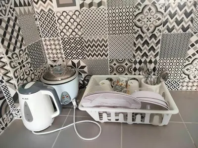 a kitchen counter with a sink and a patterned wall at IFS SoHo 2 Basic Studio in Seri Iskandar