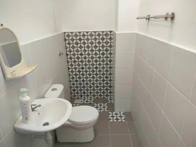 a bathroom with a white toilet and a sink at IFS SoHo 2 Basic Studio in Seri Iskandar