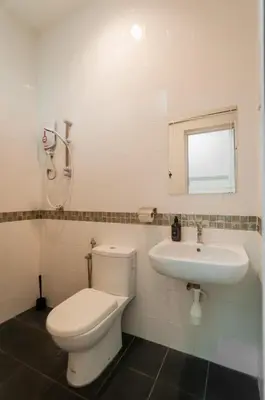 a bathroom with a toilet and a sink at Aayu Church St - 7 mins to Esplanade, George Town in George Town