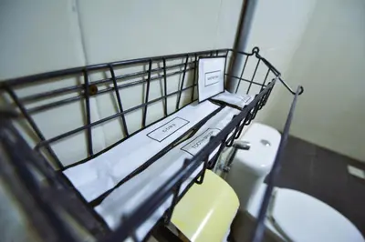 a metal bunk bed in a bathroom with a toilet at AZYA Hotel in TanjongMalim