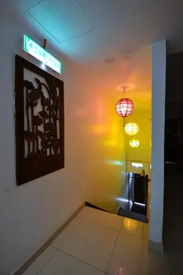 a room with two lights and a sign on the wall at AZYA Hotel in TanjongMalim