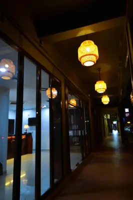 a hallway of a store with chandeliers and a hallwayngthngthngthngth at AZYA Hotel in TanjongMalim