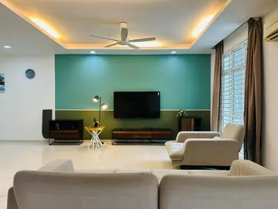a living room with a couch and a flat screen tv at Shamrock Bay Haven 5BR Homestay for 22pax at B Ferringghi in Batu Ferringhi