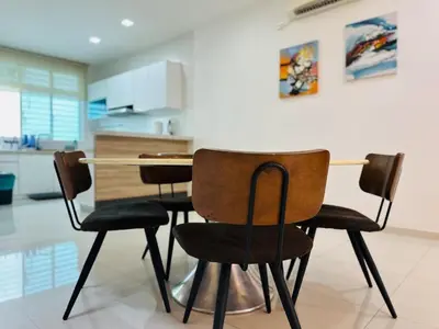 a dining room table and chairs in a kitchen at Shamrock Bay Haven 5BR Homestay for 22pax at B Ferringghi in Batu Ferringhi