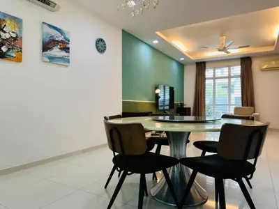a dining room with a table and chairs at Shamrock Bay Haven 5BR Homestay for 22pax at B Ferringghi in Batu Ferringhi