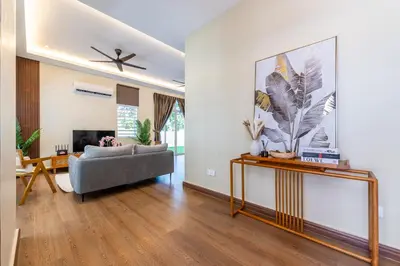a living room with a couch and a tv at La Ferringhi Villa - Tropical Collection, by ALV in Batu Ferringhi