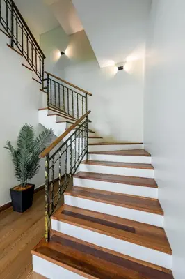 a staircase in a house with wood and white walls at La Ferringhi Villa - Tropical Collection, by ALV in Batu Ferringhi
