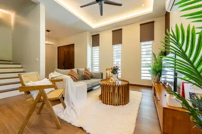 a living room with a couch and a table at La Ferringhi Villa - Tropical Collection, by ALV in Batu Ferringhi