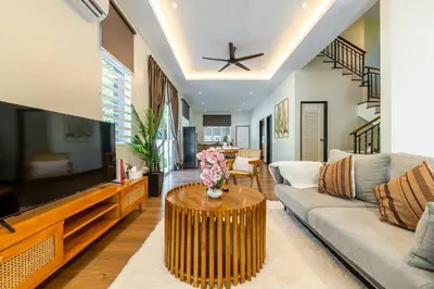 a living room with a couch and a large tv at La Ferringhi Villa - Tropical Collection, by ALV in Batu Ferringhi