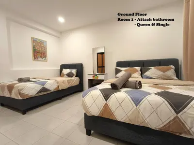 a bedroom with two beds and a mirror at Fair Park 2 at Ipoh Town Center in Ipoh