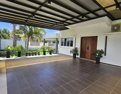 an open patio with a wooden door and potted plants at Fair Park 2 at Ipoh Town Center in Ipoh