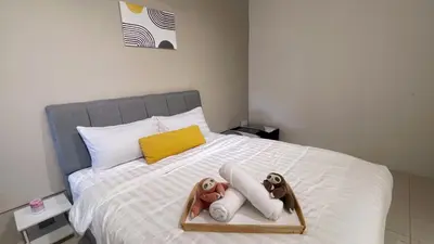 a bed with two stuffed animals sitting on it at BM IconCity Landed Home by Wemestay - Near AutoCity, Juru, Penang Bridge in Bukit Mertajam