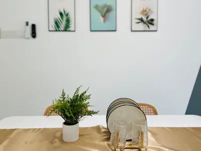 a table with two glasses and a plant on it at Mansion One l 7 pax 2R2B l Cityview l Gleneagles l by PerfectSweetHome in George Town