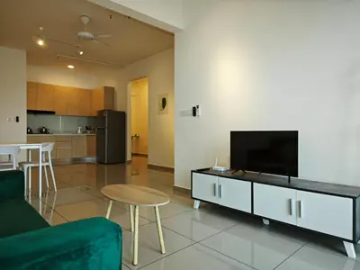 a living room with a couch and a tv at Metropol Serviced Apartment - Bukit Mertajam, Penang in Bukit Mertajam