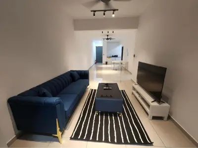 a living room with a blue couch and a table at Metropol Serviced Apartment - Bukit Mertajam, Penang in Bukit Mertajam