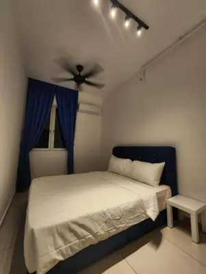 a bedroom with a bed with a ceiling fan at Metropol Serviced Apartment - Bukit Mertajam, Penang in Bukit Mertajam