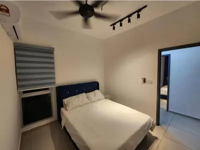 a bedroom with a bed and a ceiling fan at Metropol Serviced Apartment - Bukit Mertajam, Penang in Bukit Mertajam