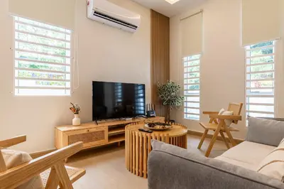 a living room with a tv and a couch at La Ferringhi Villa - Ryokan Collection, by ALV in Batu Ferringhi