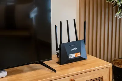 a television with a box on top of a table at La Ferringhi Villa - Ryokan Collection, by ALV in Batu Ferringhi