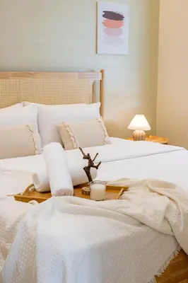 two beds with white sheets and a tray with a candle at La Ferringhi Villa - Ryokan Collection, by ALV in Batu Ferringhi