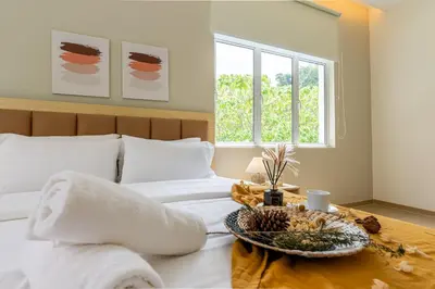 a bedroom with a bed with a tray of food on it at La Ferringhi Villa - Ryokan Collection, by ALV in Batu Ferringhi