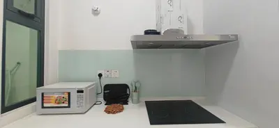 a kitchen counter with a microwave and a black speaker at Island Jazz Loft with Bathtub & Seaview - Jazz Suites by Ocean Luxe in Tanjong Tokong