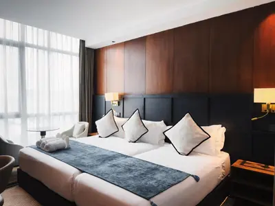 a hotel room with a large bed with white pillows at Moon Hotel in George Town