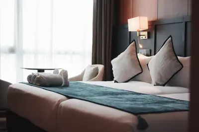 a hotel room with a bed and a window at Moon Hotel in George Town
