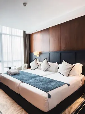 a large bed in a hotel room with a large bed sidx sidx sidx at Moon Hotel in George Town