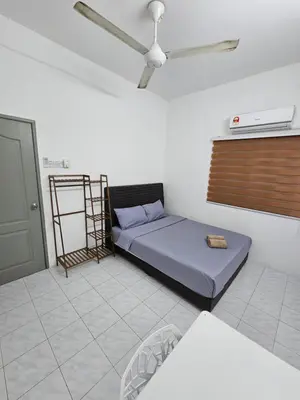 a bedroom with a bed and a ceiling fan at Double S Hostel in Ipoh