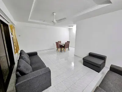 a living room with two couches and a table and chairs at Double S Hostel in Ipoh