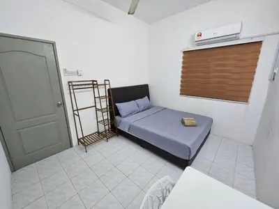 a small room with a bed and a door at Double S Hostel in Ipoh