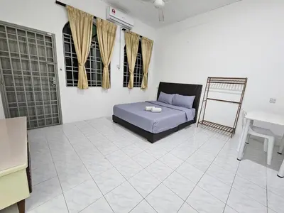 a bedroom with a bed in the middle of a room at Double S Hostel in Ipoh