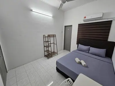 a bedroom with a blue bed in a room at Double S Hostel in Ipoh