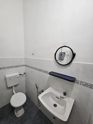 a bathroom with a toilet and a sink and a mirror at Double S Hostel in Ipoh