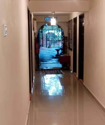 a hallway of a building with a glass door at Ali's Guest House in Batu Ferringhi