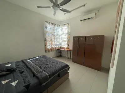 a bedroom with a bed and a ceiling fan at MDRS Seroja 7 in Kuala Ketil