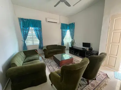 a living room with a couch and chairs and a table at MDRS Seroja 7 in Kuala Ketil