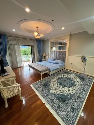 a bedroom with a bed and a rug at Anandavilla in Seri Manjung