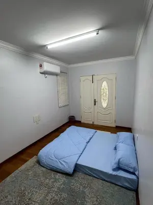 a bedroom with a bed with a blue comforter at Anandavilla in Seri Manjung