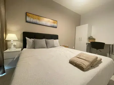 a bedroom with a large white bed with a blanket at Ipoh The Anderson 5pax Suite #82 in Ipoh