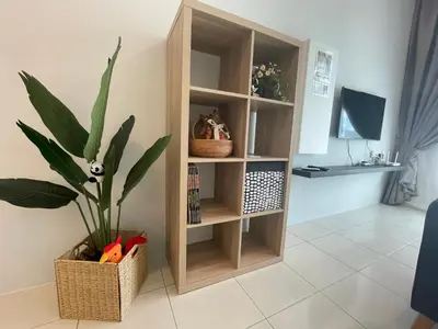 a book shelf with a plant in a room at Ipoh The Anderson 5pax Suite #82 in Ipoh