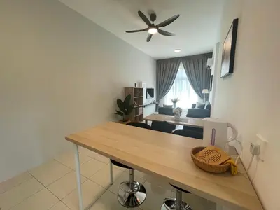 a living room with a table and a ceiling fan at Ipoh The Anderson 5pax Suite #82 in Ipoh