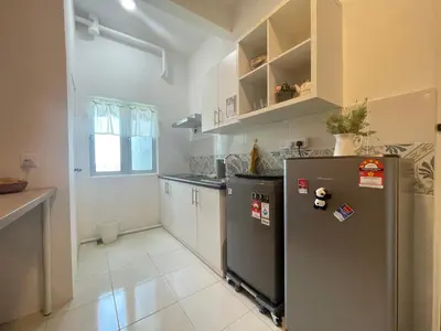 a kitchen with a stainless steel refrigerator and cabinets at Ipoh The Anderson 5pax Suite #82 in Ipoh