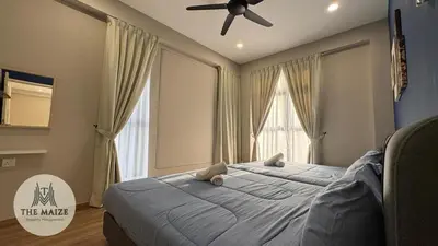 a bedroom with a large bed with a ceiling fan at Verdant Sunset The Cove Ipoh in Ipoh