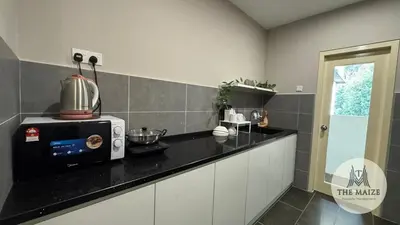 a kitchen with a counter with a microwave on it at Verdant Sunset The Cove Ipoh in Ipoh