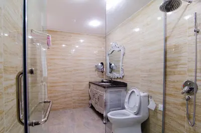 a bathroom with a toilet and a sink and a shower at Mornington Hotel Sitiawan in Sitiawan