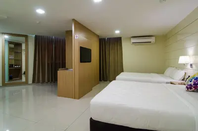 a hotel room with two beds and a tv at Mornington Hotel Sitiawan in Sitiawan